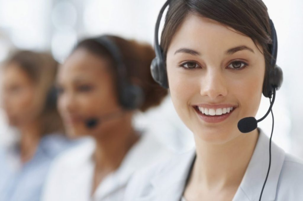 Closeup of a cute business woman with headset at workplace